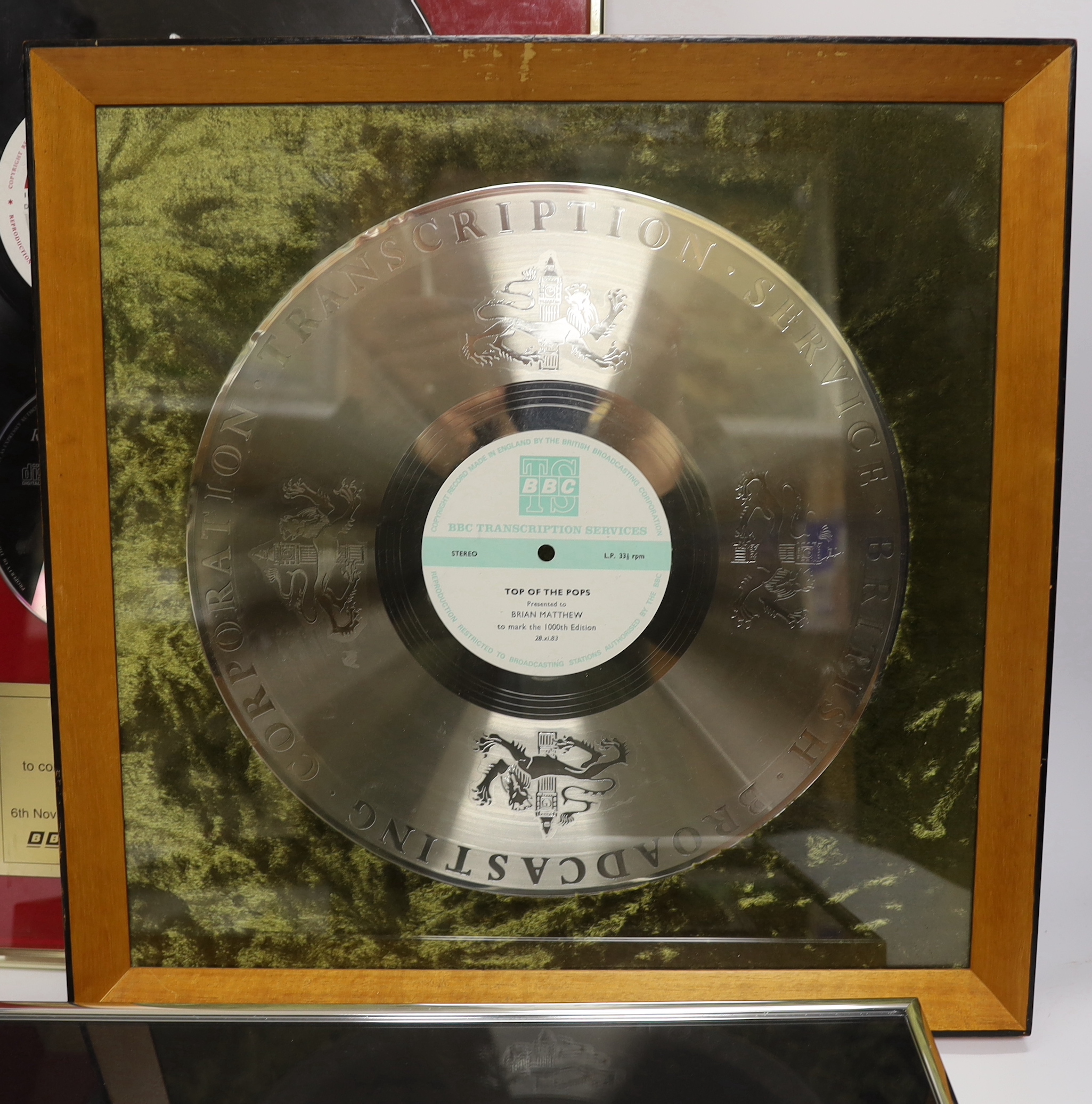 Three framed BBC related presentations to the BBC DJ Brian Matthew; ‘The Beatles - Live at the BBC’, presented by EMI Records, Top of the Pops presented to mark the 1000th edition (28.11.83), Top of the Pops, presented t